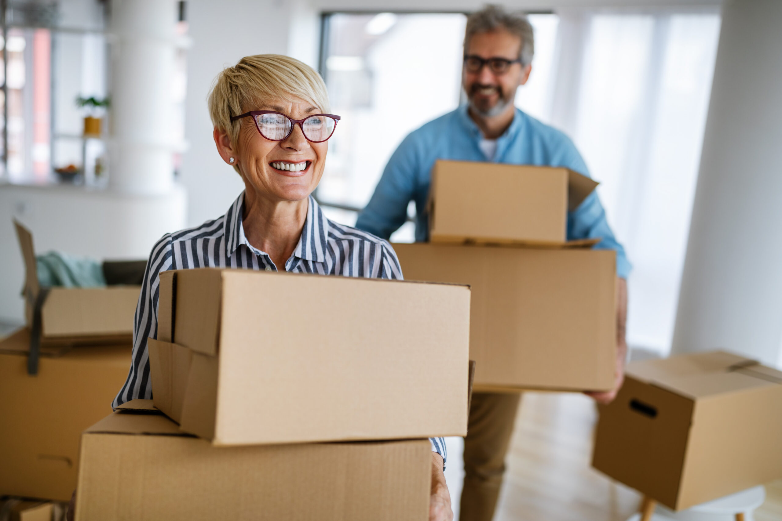 Portrait of happy senior couple in love moving in new home
